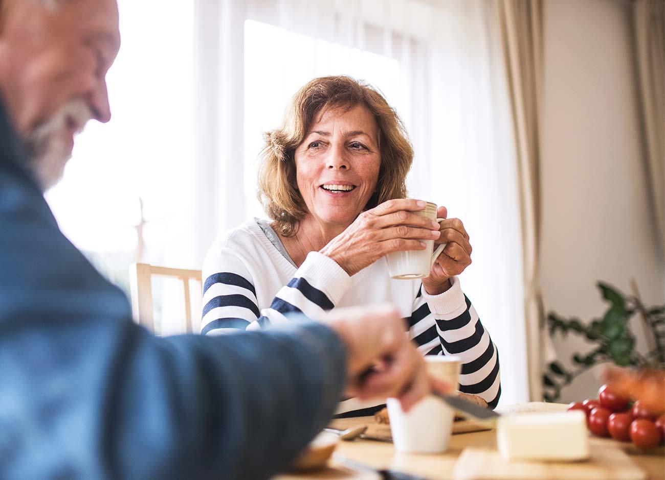 older couple enjoying coffee together at home