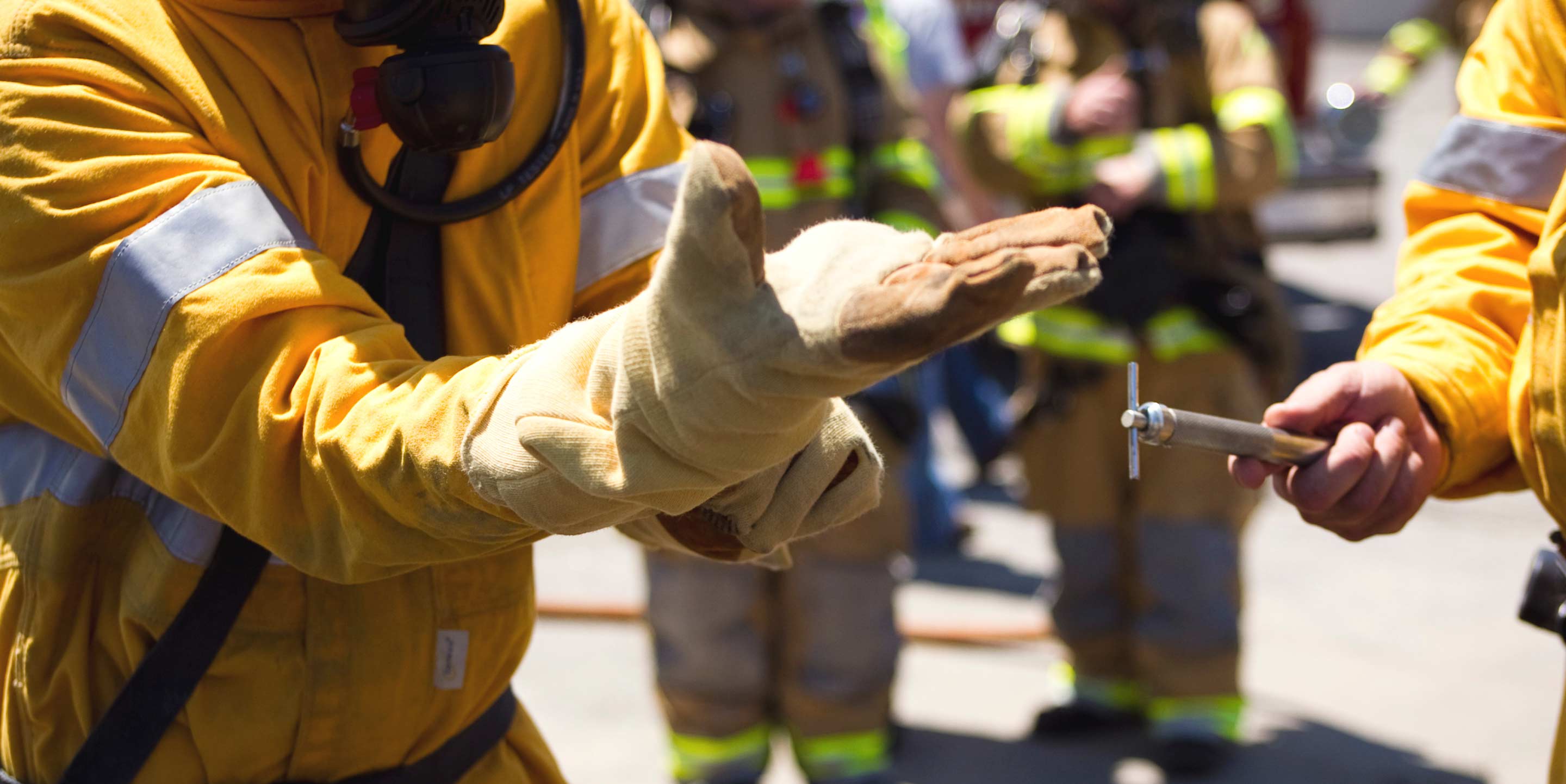 close up of Unitil gas worker putting on glove during drill