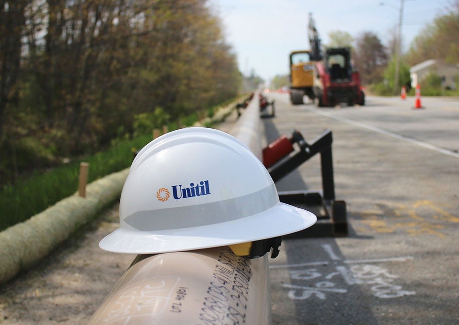 Unitil gas pipeline with hardhat placed on exposed pipe