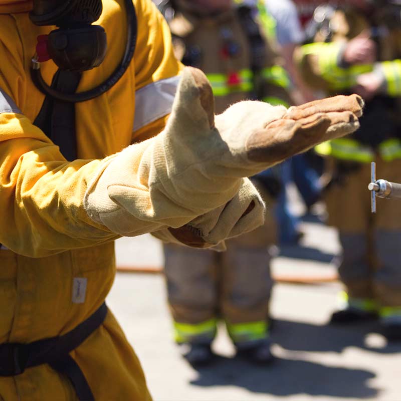 close up of gas worker putting on glove during drill