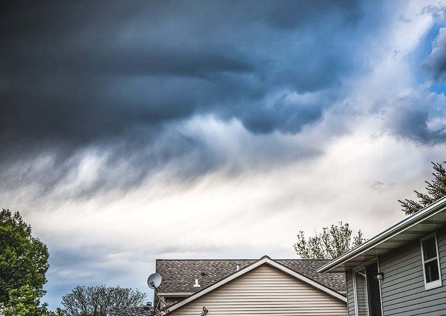 storm clouds over suburban houses
