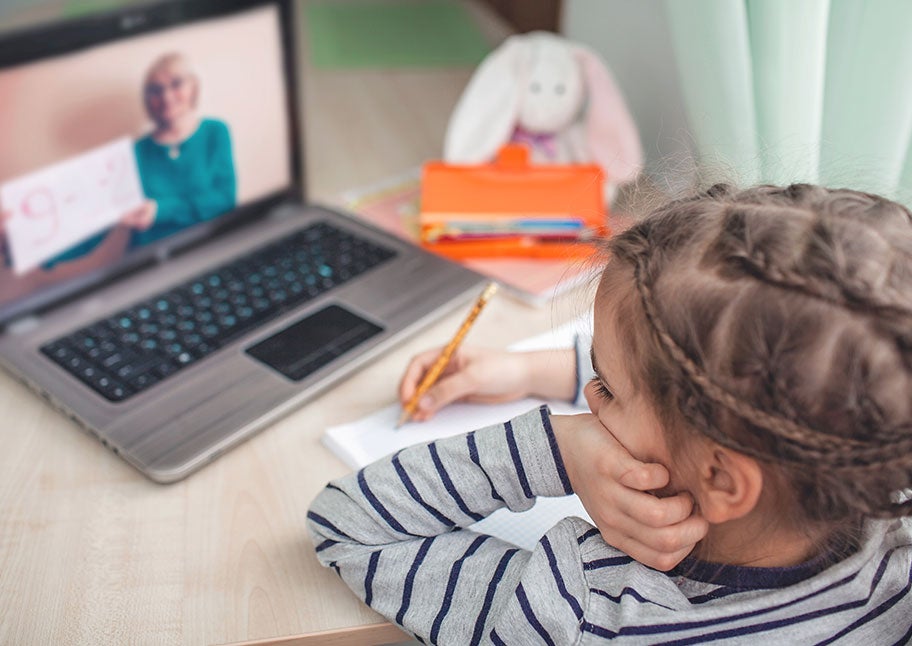 little girl doing online lesson at home
