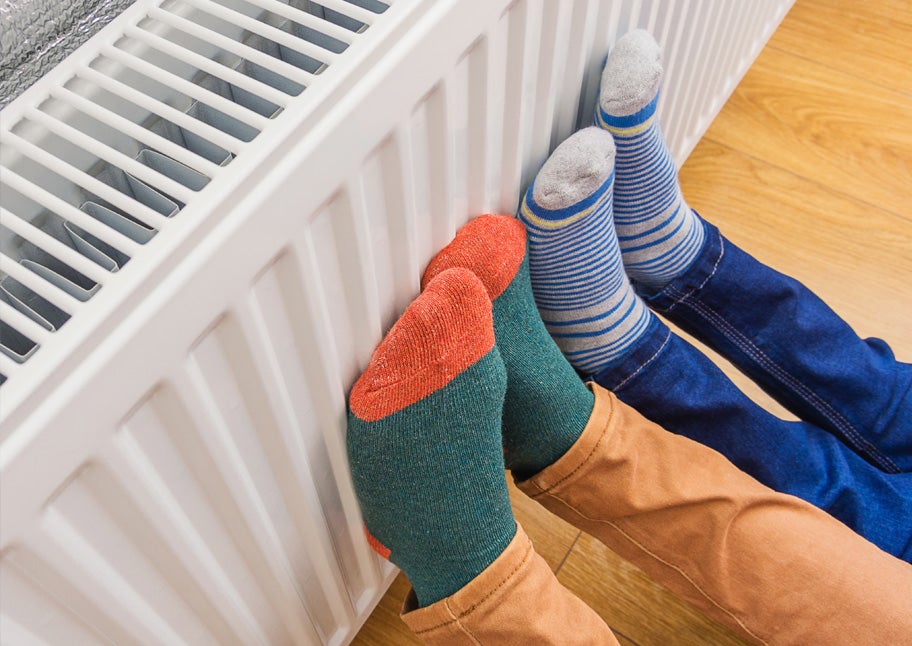 feet with socks rest against heater