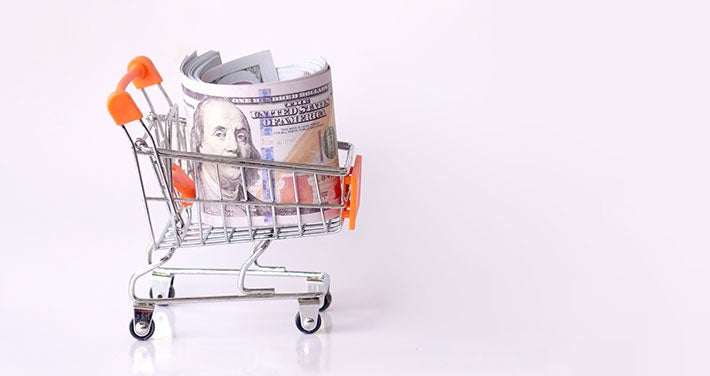 small shopping cart with a roll of money