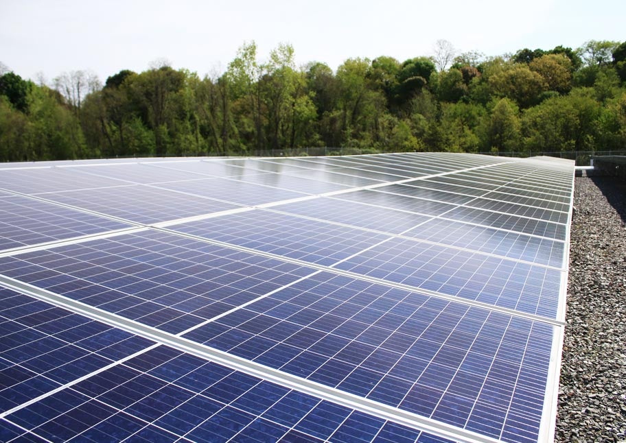 long view of solar panel with trees in background