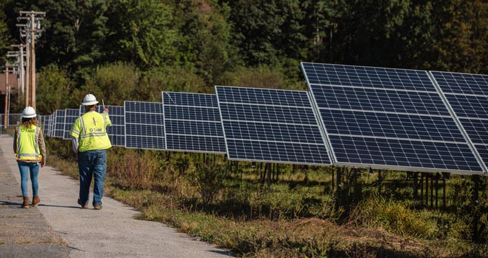 Two Unitil employees in a solar field