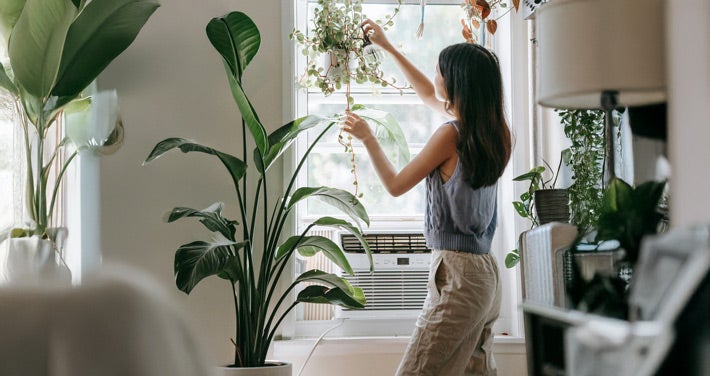women in home with window air conditioner