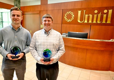 George Anderson and Jacob Dusling holding NHEnergy Week awards