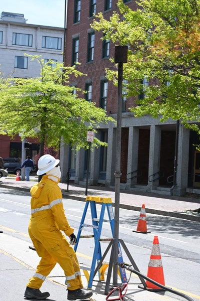 worker sets up pipe for gas flair