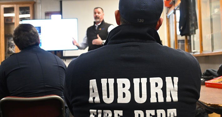 Members of the Auburn Fire Department listen to Mark Dupuis, Unitil’s director of Gas System and Transmission Operations