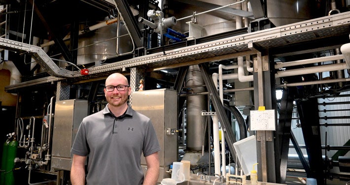 Trevor Bland stands by heat exchange of the brewhouse