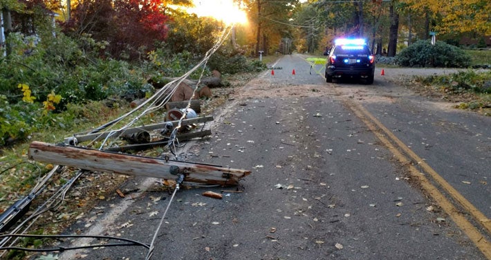 A broken utility pole lying on the road.