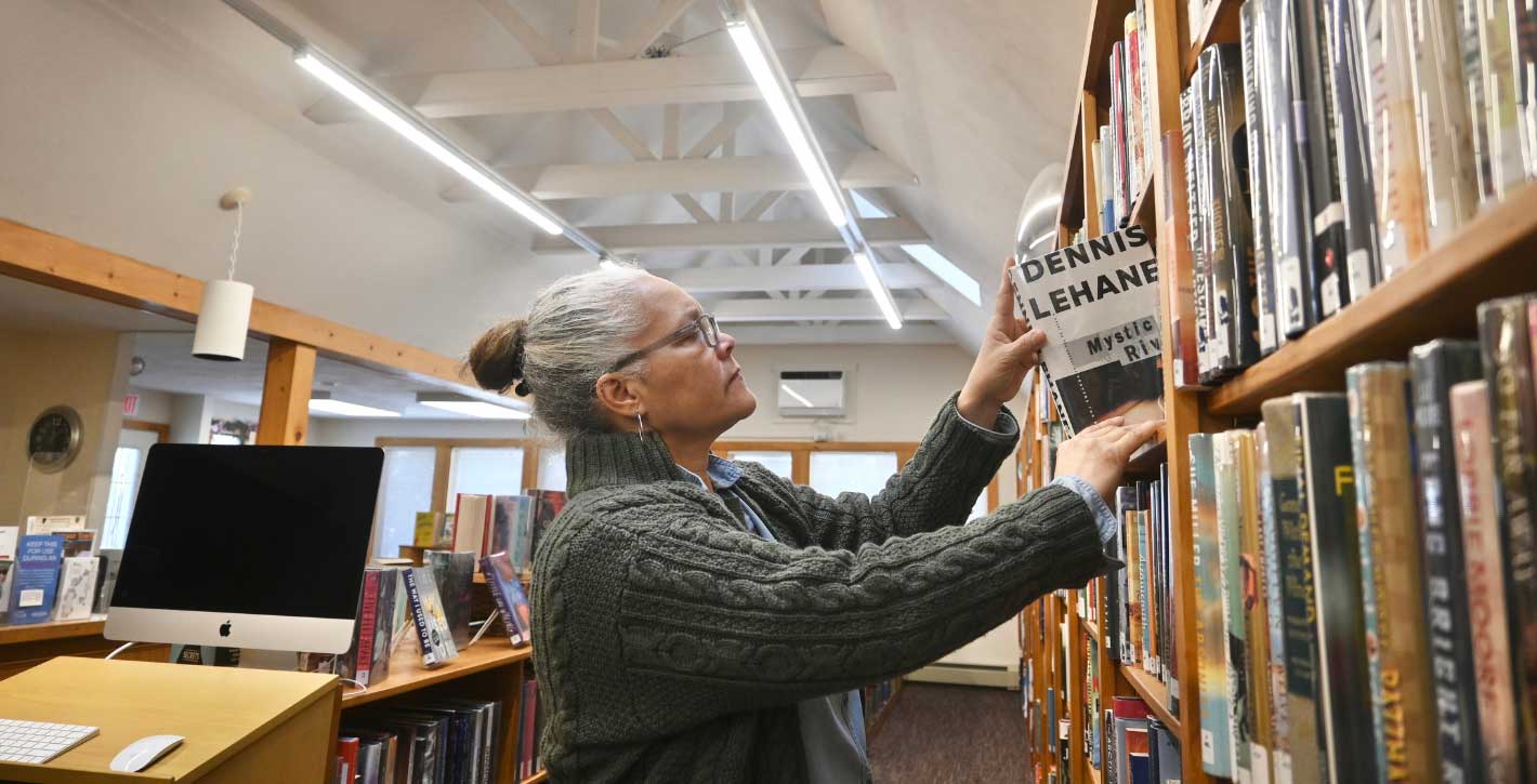 Librarian putting book away