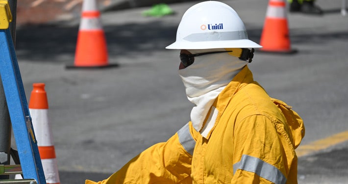 worker in protective gear at a gas flair