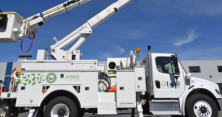 side view of hybrid electric bucket truck with sky in background