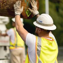 Unitil electric crew member handling pole