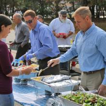 CEO Tom Meissner serving food at a community event.