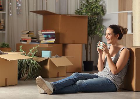woman sitting with boxes to unpack
