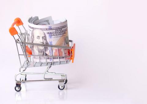 small shopping cart with roll of money