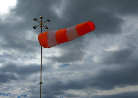 wind sock blows with dark clouds in background