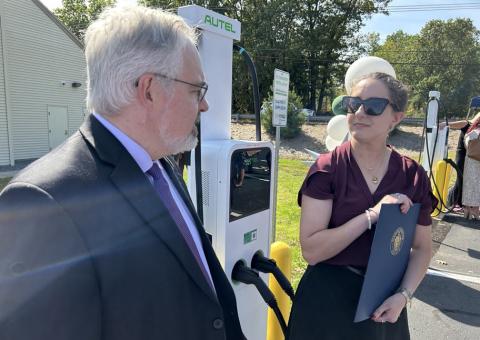 Unitil employees at a ribbon cutting for a Level 2 EV charging station
