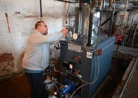 Mike Green, maintenance manager at the Wentworth Home assisted living facility in Dover, looks over the new natural gas system that replaced an older oil-fired boiler.