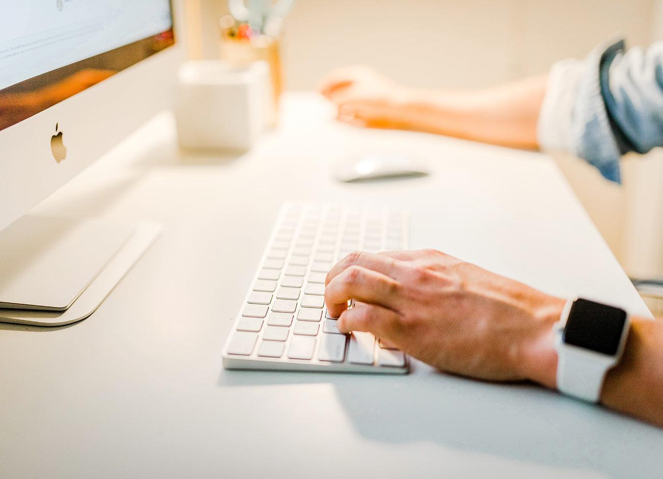 Person typing on keyboard