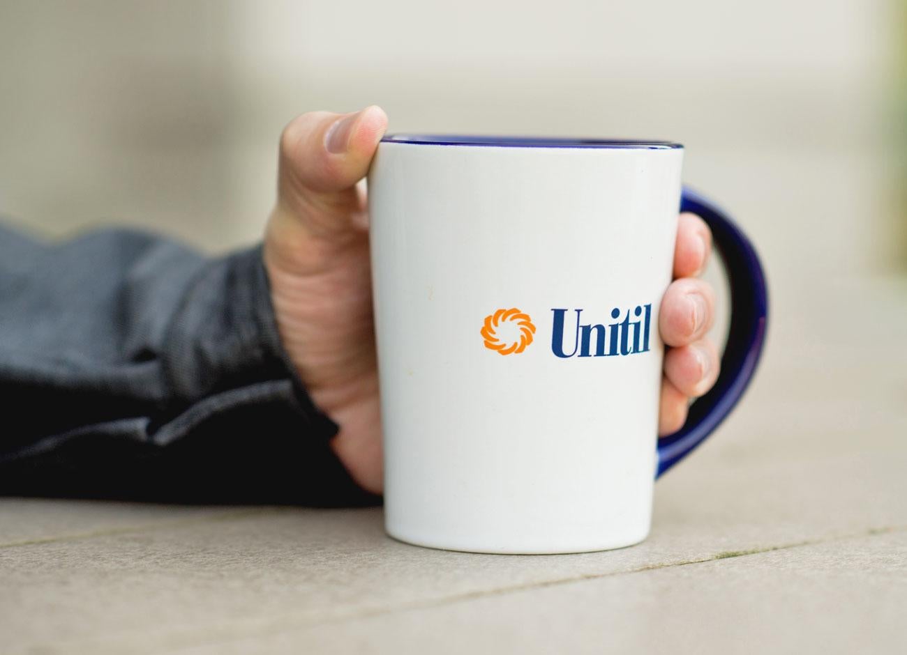 Closeup of a Unitil branded coffee mug.