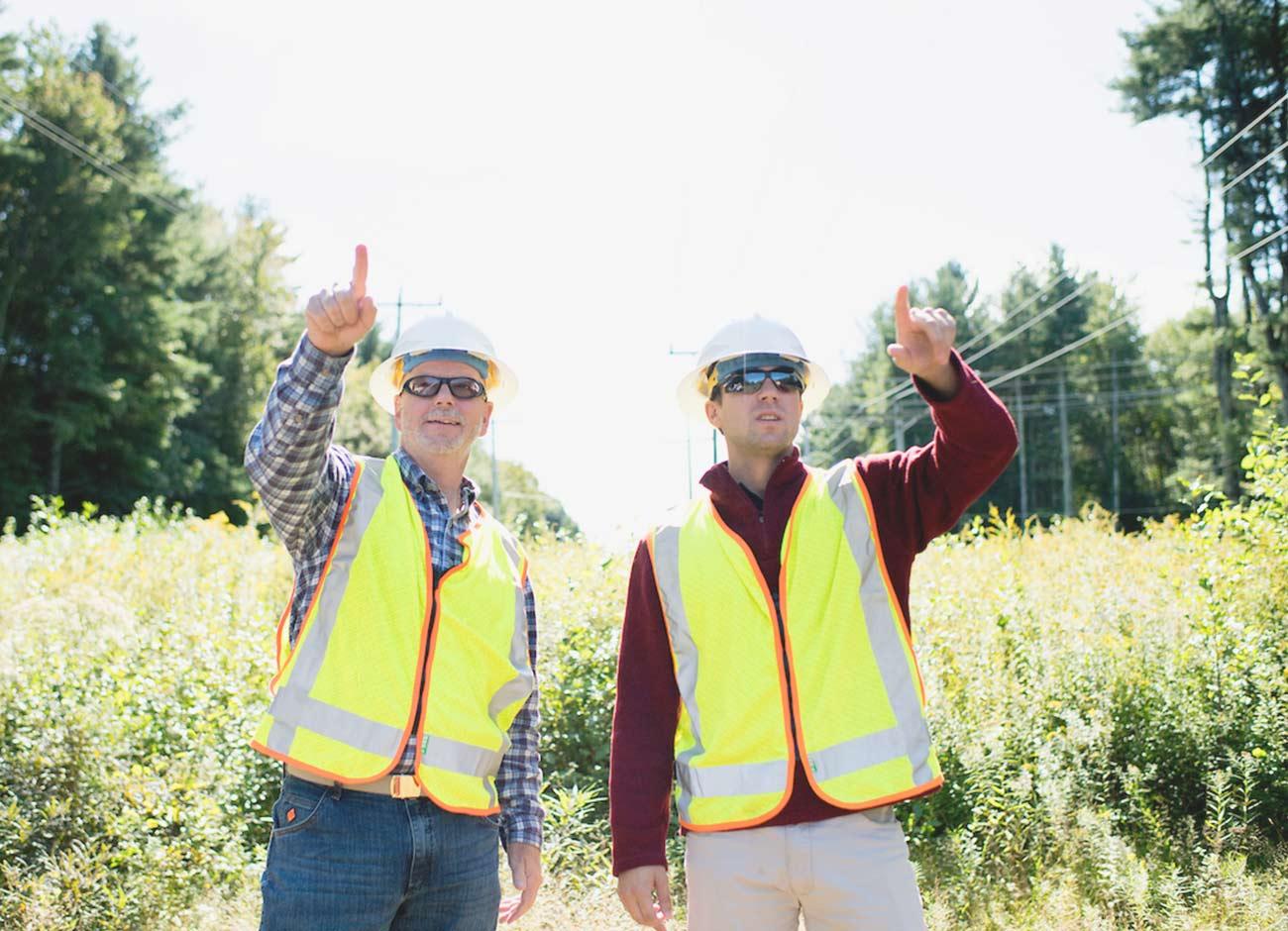 Unitil safety crew pointing at power lines