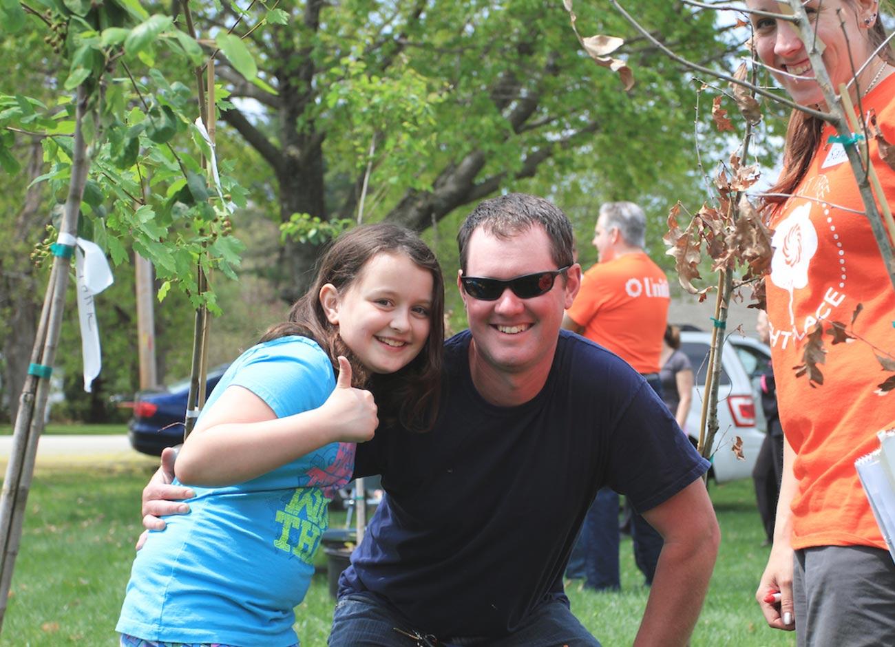 father and daughter picking out new tree at Unitil tree event
