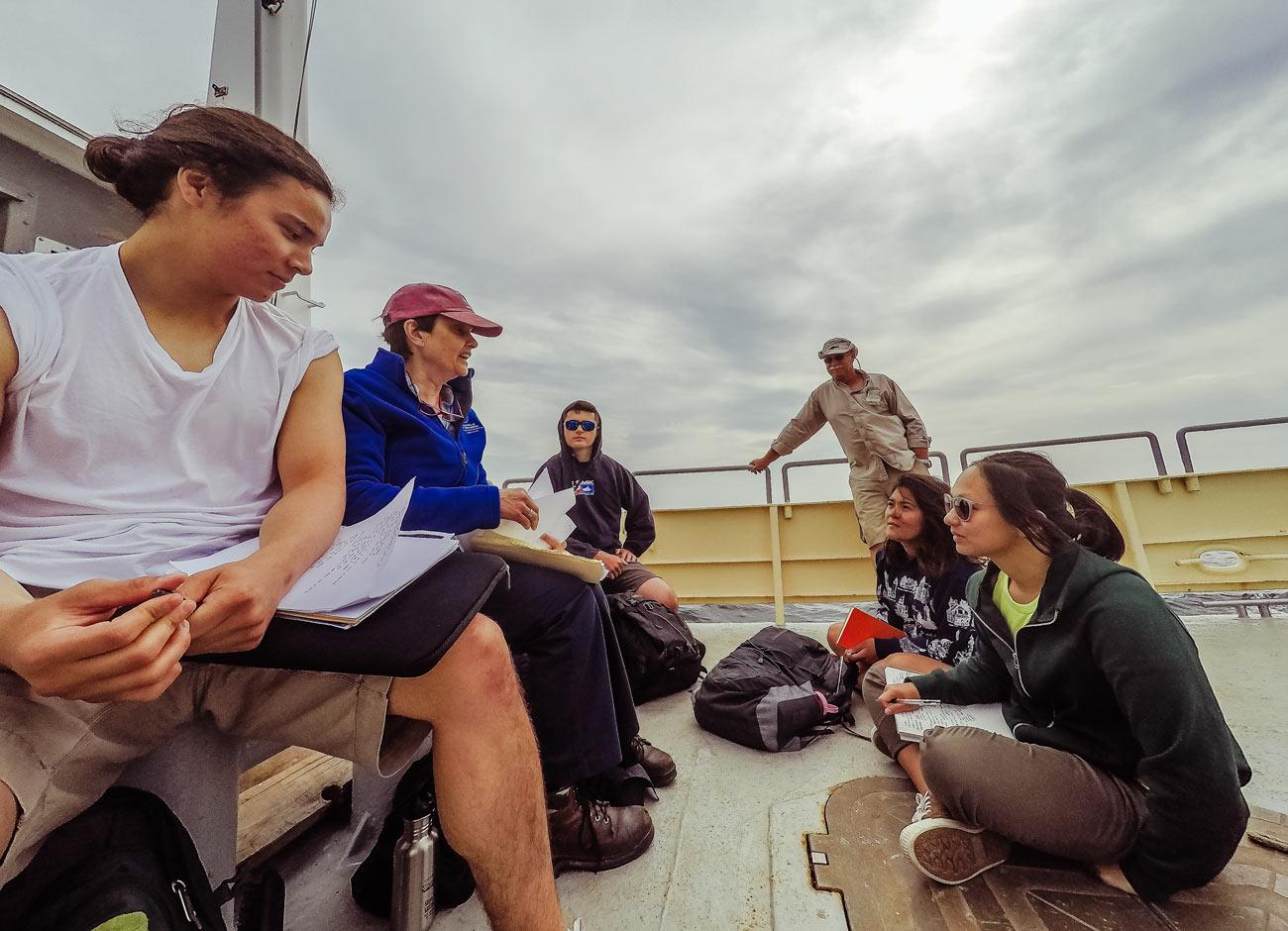 Shoals Marine lab interns learn on a boat to the island